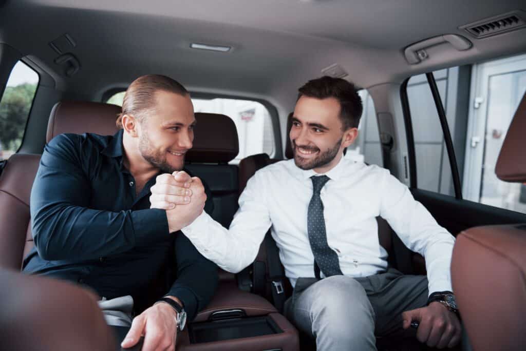 The two old business friends conclude a new agreement in an informal setting in the car's
