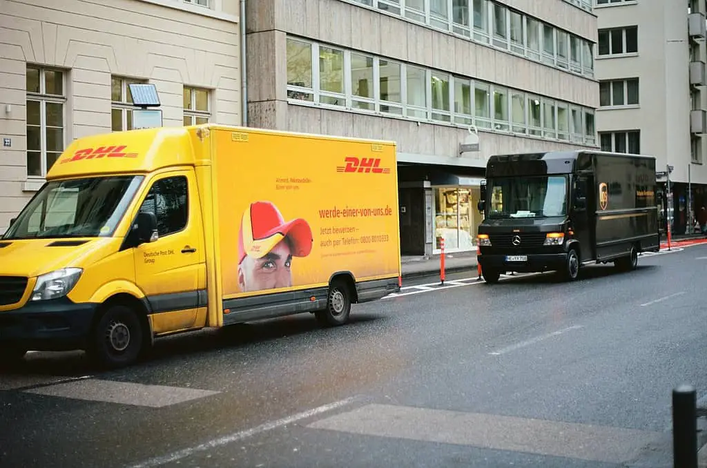 a yellow van and a black van on a street